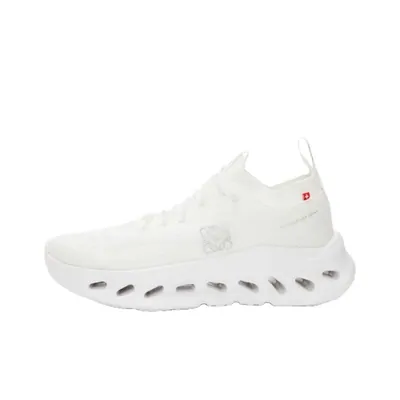 A white low-top sneaker photographed from the side on a white background